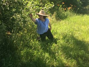 woman with hat dancing outside